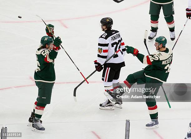 Nino Niederreiter of the Minnesota Wild celebrates his goal at 2:26 of the second period against the Chicago Blackhawks and is joined by Erik Haula...