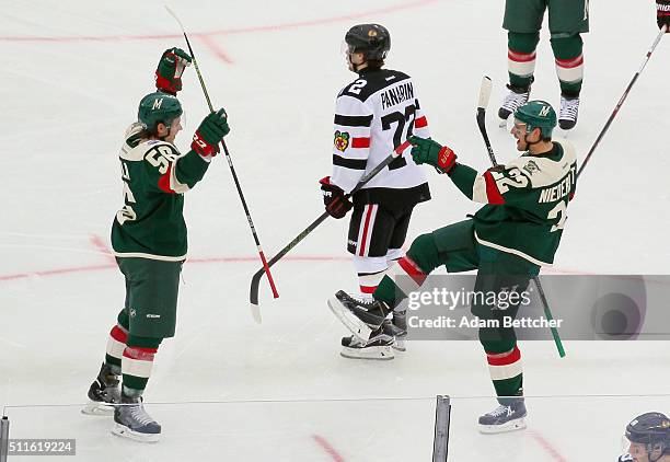 Nino Niederreiter of the Minnesota Wild celebrates his goal at 2:26 of the second period against the Chicago Blackhawks and is joined by Erik Haula...