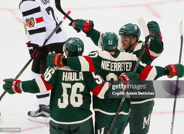 Nino Niederreiter of the Minnesota Wild celebrates his goal at 2:26 of the second period against the Chicago Blackhawks and is joined by Erik Haula...