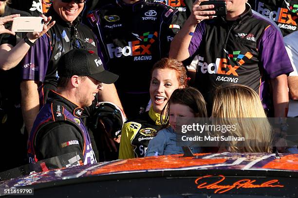 Denny Hamlin, driver of the FedEx Express Toyota, celebrates in Victory Lane with his wife, Jordan Fish, and daughter, Taylor, after winning the...