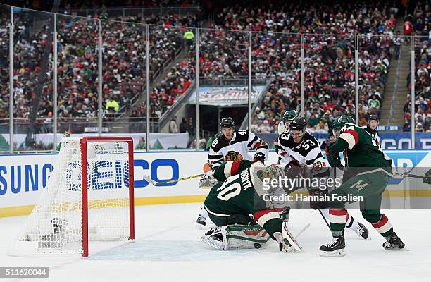 Devan Dubnyk of the Minnesota Wild makes the second period save as Brandon Mashinter of the Chicago Blackhawks looks for the rebound at the TCF Bank...