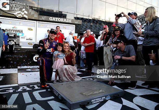 Denny Hamlin, driver of the FedEx Express Toyota, celebrates with his girlfriend, Jordan Fish, and daughter, Taylor in Victory Lane after putting his...