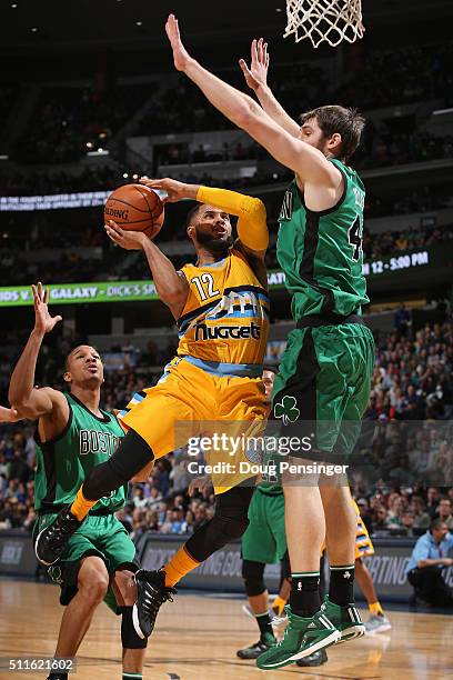 Augustin of the Denver Nuggets tries to get off a shot against Tyler Zeller of the Boston Celtics at Pepsi Center on February 21, 2016 in Denver,...