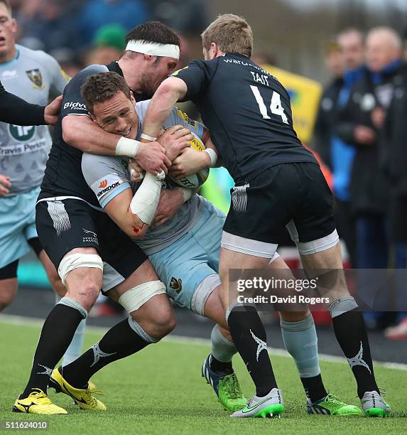 James Wilson of Northampton is tackled by Will Welch and Alex Tait during the Aviva Premiership match between Newcastle Falcons and Northampton...