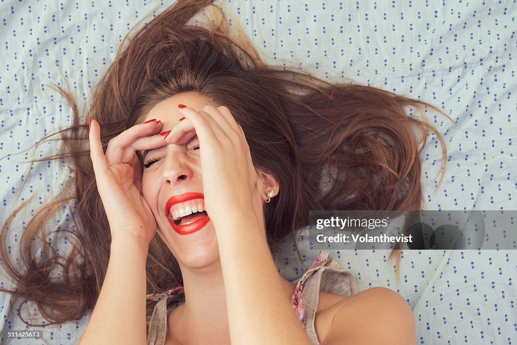 Beautiful happy woman laughing w/ hands on face