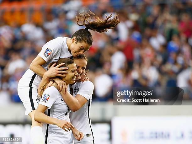 Kelly O'Hara, Lindsey Horan and Tobin Heath of the United States celebrate after Heath scored a second half goal against Canada during the...