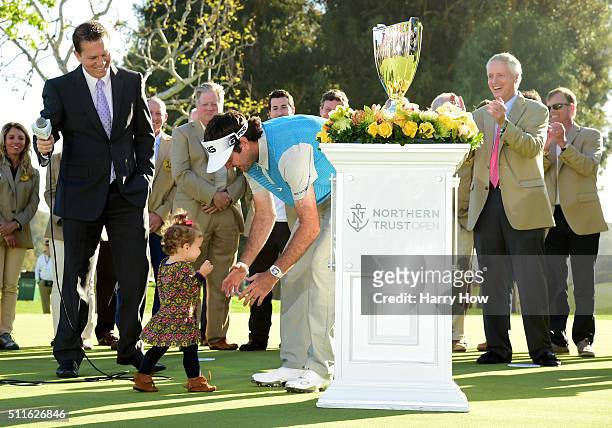 Bubba Watson goes to hug his daughter Dakota during the trophy presentation after putting in to win on the 18th hole during the final round of the...
