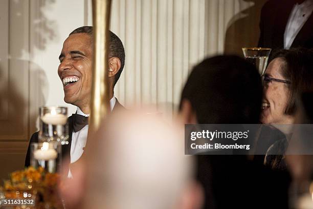 President Barack Obama reacts as Gary Herbert, governor of Utah, not pictured, speaks during a National Governors Association dinner and reception in...