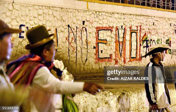 An aymara woman is seen walking next to a graffiti that reads "No Evo" after the referendum rejection in El Alto, Bolivia, on February 21. Bolivians...