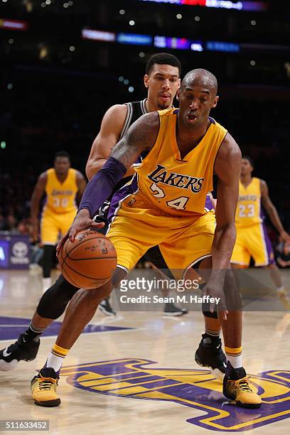 Kobe Bryant of the Los Angeles Lakers dribbles past Danny Green of the San Antonio Spurs during the second half of a game at Staples Center on...