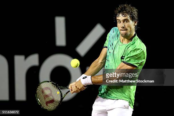 Guido Pella of Argentina returns a shot against Pablo Cuevas of Uraguay during the final of the Rio Open at Jockey Club Brasileiro on February 21,...