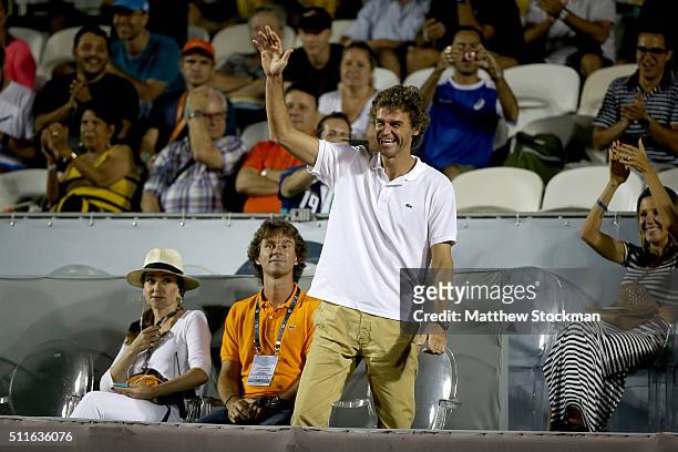 Gustavo Kuerten of Brazil acknowledge the applause from the crowd as he takes his seat for the Guido Pella of Argentina verses Pablo Cuevas of...