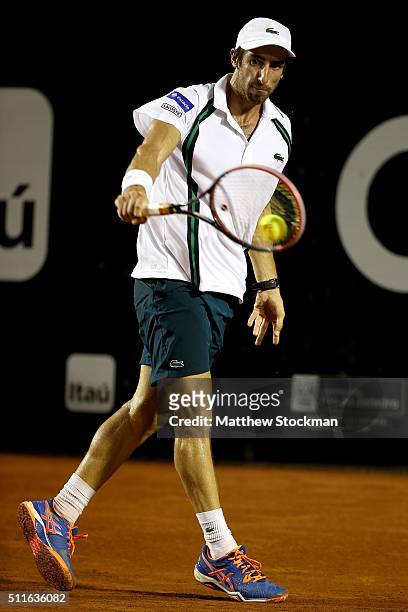 Pablo Cuevas of Uraguay returns a shot against Guido Pella of Argentina during the final of the Rio Open at Jockey Club Brasileiro on February 21,...