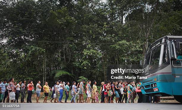 Family members and other visitors wait to board a bus departing from the Anisio Jobim penitentiary complex after visiting inmates on February 19,...