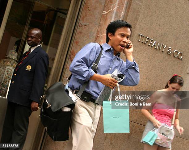 Shopper walks out of the storefront of Tiffany & Co. August 12, 2004 in New York City. The luxury jeweler announced August 12 that quarterly profit...