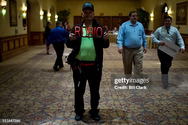 Marco Rubio supporter John Mendonca, of Las Vegas, holds up a neon "RUBIO" sign outside of Marco Rubio campaign rally at the Texas Station Gambling...