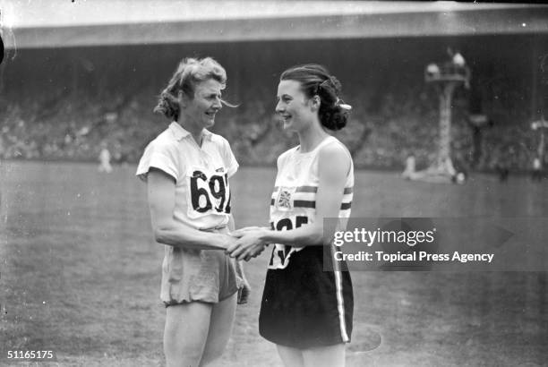 At the 1948 London Olympics, women's 80 metres hurdles silver medallist Maureen Gardner congratulates the winner of the event, Fanny Blankers-Koen of...