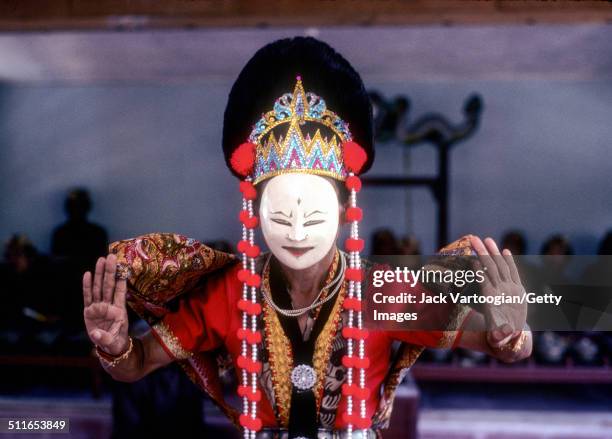 In a mask, Indonesian dancer Arja Sujana performs during a portion of a cycle of traditional masked dances called 'Topeng Cirebon', Cirebon, North...