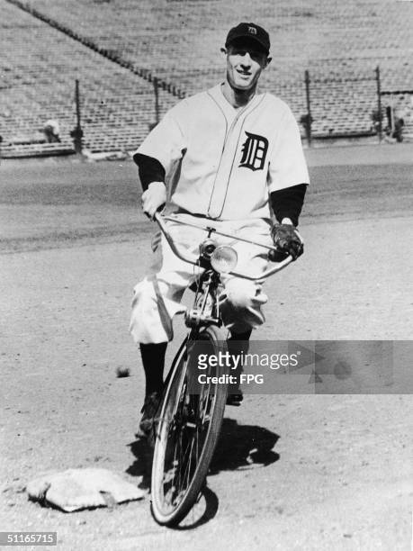 American baseball player Joyner 'Jo-Jo' White , outfielder for the Detroit Tigers from 1932 to 1938, rides a bicycle around the bases at Navin Field,...