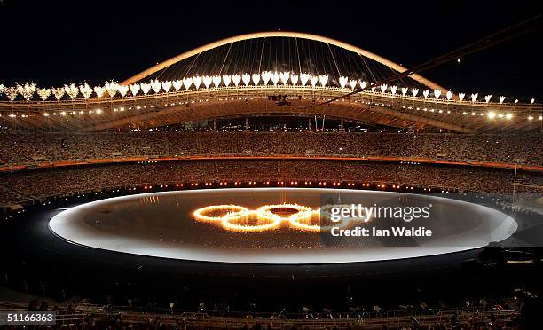 The Olympic rings are seen as fireworks are ignited during the opening ceremony of the Athens 2004 Summer Olympic Games on August 13, 2004 at the...