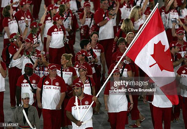 Flag bearer Nicolas Gill leads team Canada during opening ceremonies for the Athens 2004 Summer Olympic Games on August 13, 2004 at the Sports...