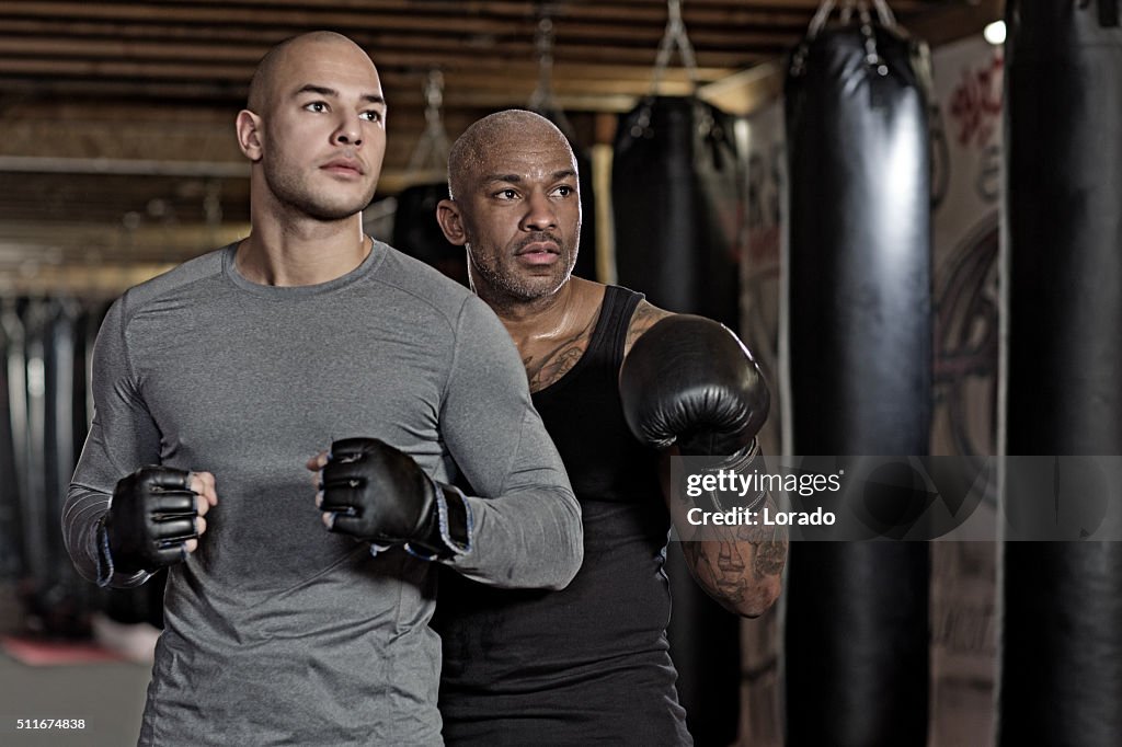 Two fighters posing at an urban boxing gym