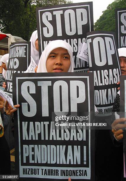 Indonesian Muslim students display placards reading "Stop Education Capitalitation" during a demonstration in Jakarta, 14 August 2004. While...