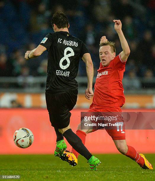 Uffe Bech of Hannover is challenged by Markus Feulner of Augsburg during the Bundesliga match between Hannover 96 and FC Augsburg at HDI-Arena on...