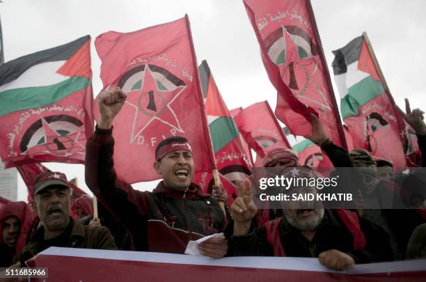 Palestinian supporters of the Democratic Front for the Liberation of Palestine shout slogans and hold flags of the movement during an anti-Israel...