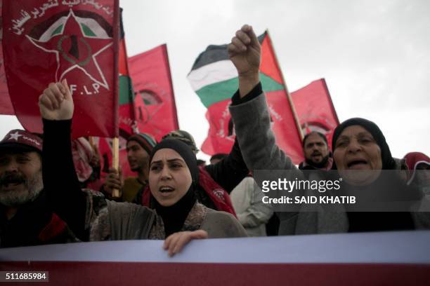 Palestinian supporters of the Democratic Front for the Liberation of Palestine shout slogans and hold flags of the movement during an anti-Israel...