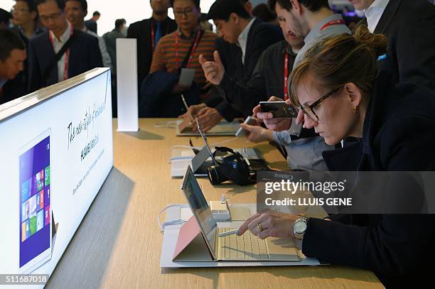 Woman tests Huawei's new "Matebook" at the Mobile World Congress in Barcelona on February 22 during the first day of the world's biggest mobile fair...