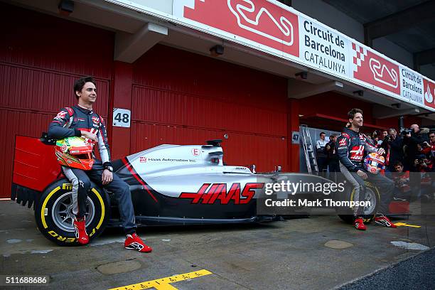 Romain Grosjean of France and Haas F1 and Esteban Gutierrez of Mexico and Haas F1 pose with the new car outside the garage during day one of F1...