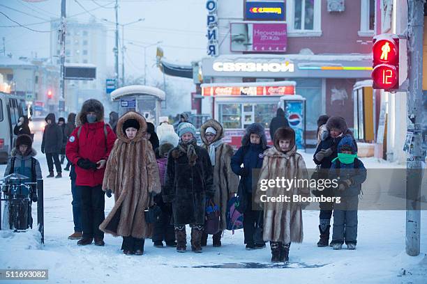 Local residents dressed in fur coats wait at a road junction in Yakutsk, Sakha Republic, Russia, on Monday, Feb. 15, 2016. Yakutsk, the capital of...