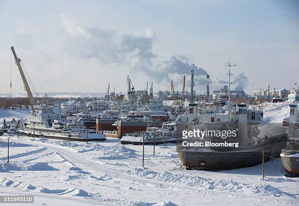 Tankers and bulk carriers sit trapped in ice at the frozen winter boatyard on the Lena River beside Zhatay village, near Yakutsk, Sakha Republic,...