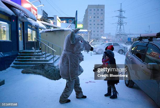 An entertainer dressed as a giant mouse entertains children at the Krestyansky open air market in Yakutsk, Sakha Republic, Russia, on Wednesday, Feb....