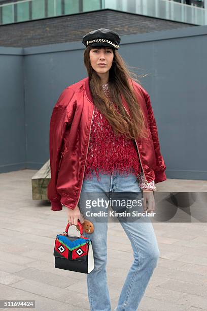 Fashion stylist Estelle Pigault wears a Pretty Little Thing jacket, Levi�âs jeans, Eugenia Kim hat, Gayeon Lee top and Les Petites Jouers bag on day 3...