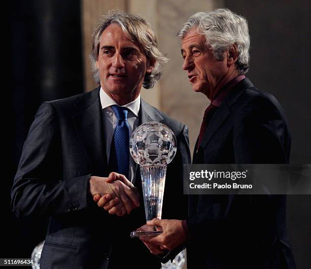 Roberto Mancini and Gianni Rivera pose showing the award during the Italian Football Federation Hall of Fame Award ceremony at Palazzo Vecchio on...