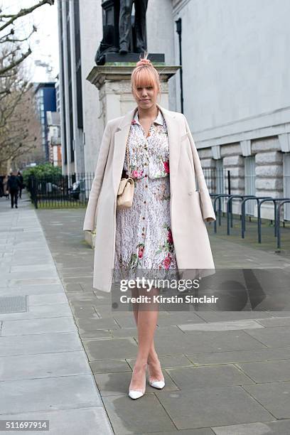 Model Amber Le Bon wears a Stella McCartney coat, Vivienne Westwood dress, Gianvito Rossi shoes and Chanel bag on day 3 during London Fashion Week...