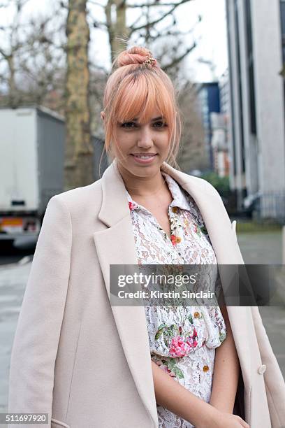 Model Amber Le Bon wears a Stella McCartney coat and Vivienne Westwood dress on day 3 during London Fashion Week Autumn/Winter 2016/17 on February...