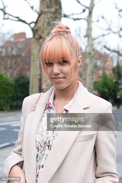 Model Amber Le Bon wears a Stella McCartney coat and Vivienne Westwood dress on day 3 during London Fashion Week Autumn/Winter 2016/17 on February...