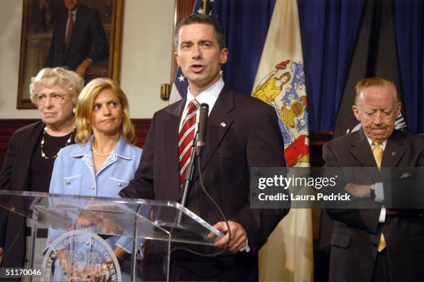 New Jersey Governor James McGreevey addresses the medeia with his wife Dina at his side where he admitted to being gay and to having an extramarital...