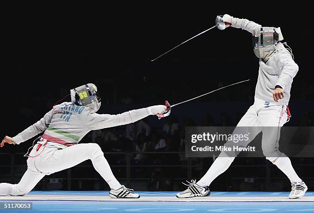 Aldo Montano of Italy duals with Dmitri Lapkes of Belarus in the men's fencing individual sabre semifinals on August 14, 2004 during the Athens 2004...