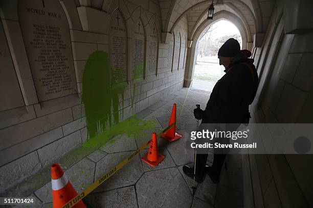 Dr. Alvin Zipursky stops to look at a war memorial that has been vandalized as he short cuts through St, Michaels at the University of Toronto as he...