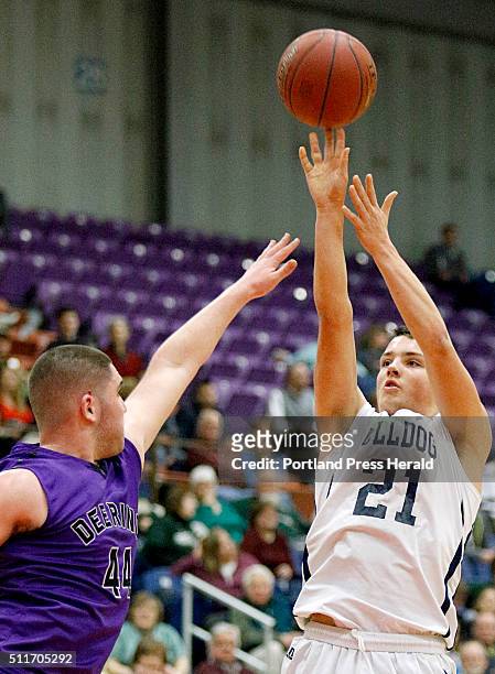 Portland's Joe Esposito shoots in the face of Deering's Raffaele Salamone during the first half of the Class AA North boys regional final Friday,...
