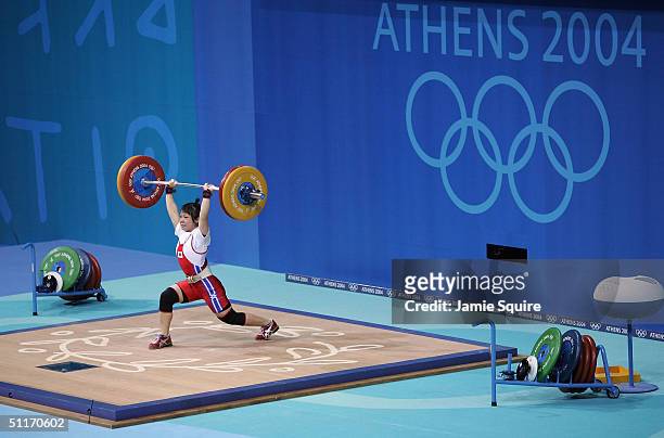 Hiromi Miyake of Japan competes during the women's 48 kg category weightlifting competition on August 14, 2004 during the Athens 2004 Summer Olympic...