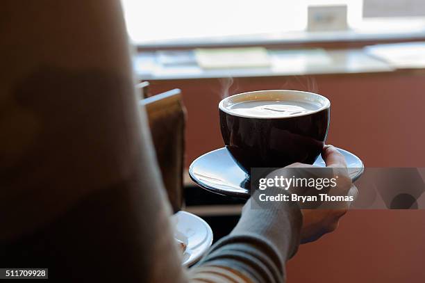 Customer carries a cup of coffee to her table at Colson Patisserie on February 22, 2016 in the Brooklyn borough of New York City. A recently released...