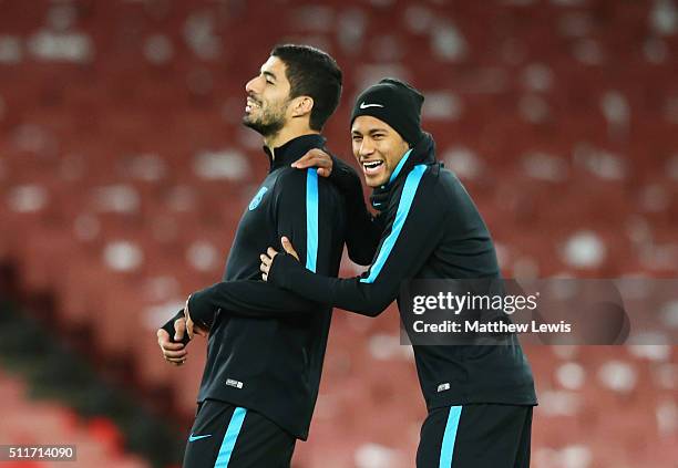 Neymar jokes with Luis Suarez of Barcelona during a FC Barcelona training session ahead of their UEFA Champions League round of 16 first leg match...