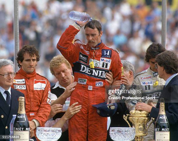 Nigel Mansell of the Williams-Honda Team, Alan Prost of the McLaren-TAG Team and Nelson Piquet of the Williams-Honda Team on the podium after the...