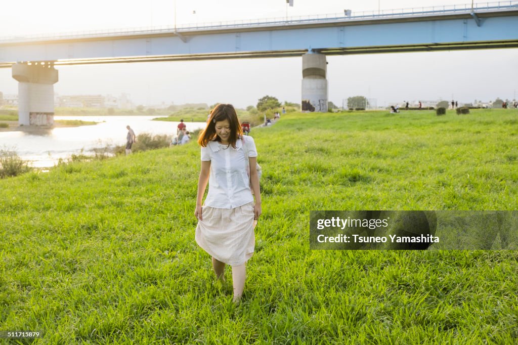 The young woman who walks along a riverside