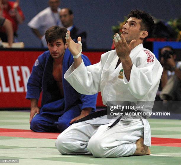 Iranian Arash Miresmaeili thanks God 28 July 2001 in Munich after defeating Ukrainian Musa Nastuyev in the men's -66 kg category at the world judo...